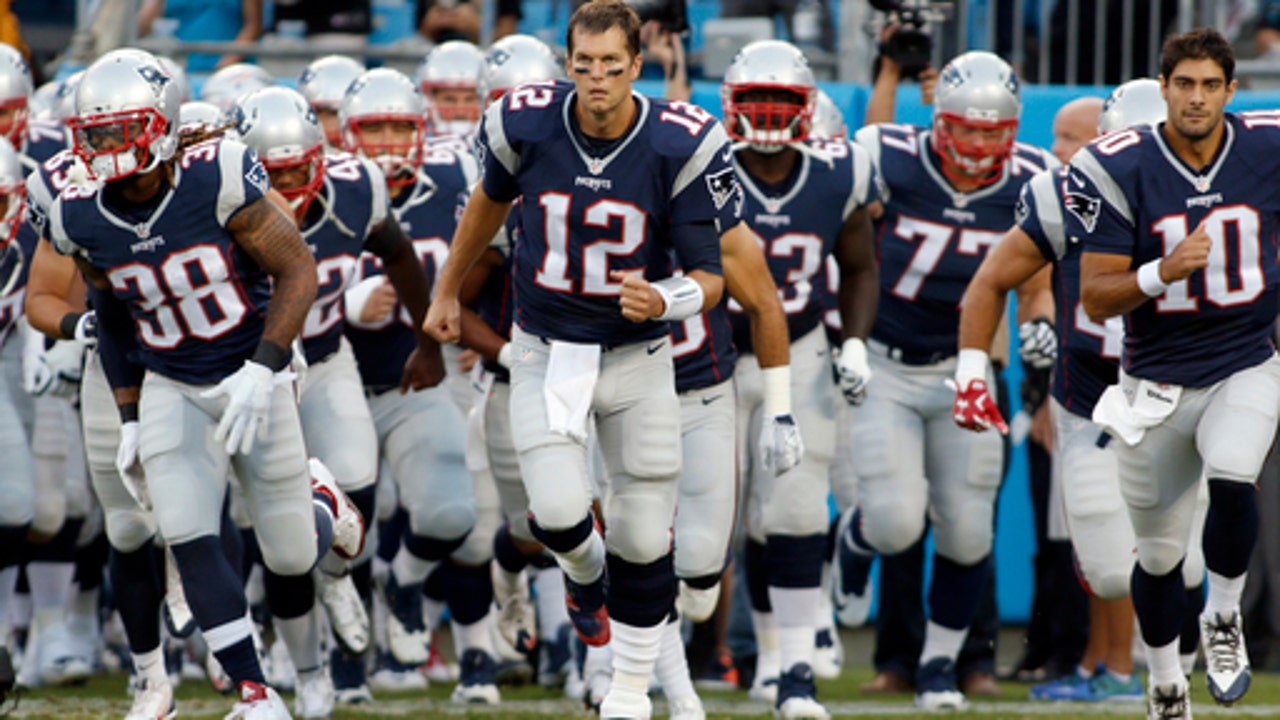 The Latest: Some raise fists, others kneel during anthem